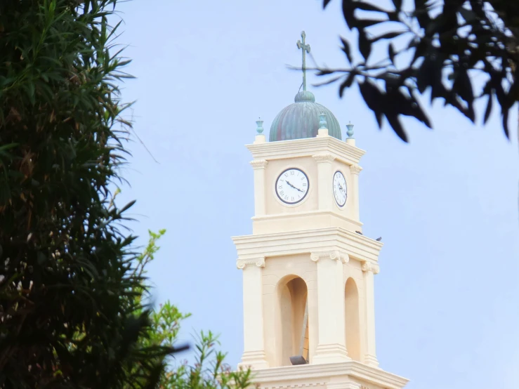 a tower with a clock has an arched top