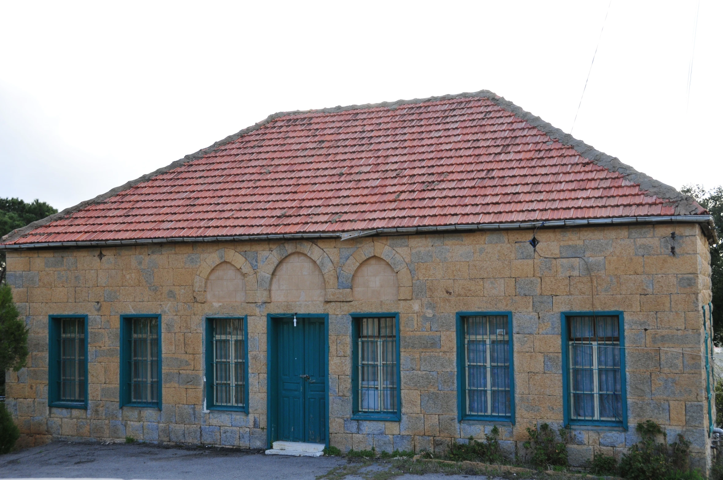 a old home with an orange shingled roof