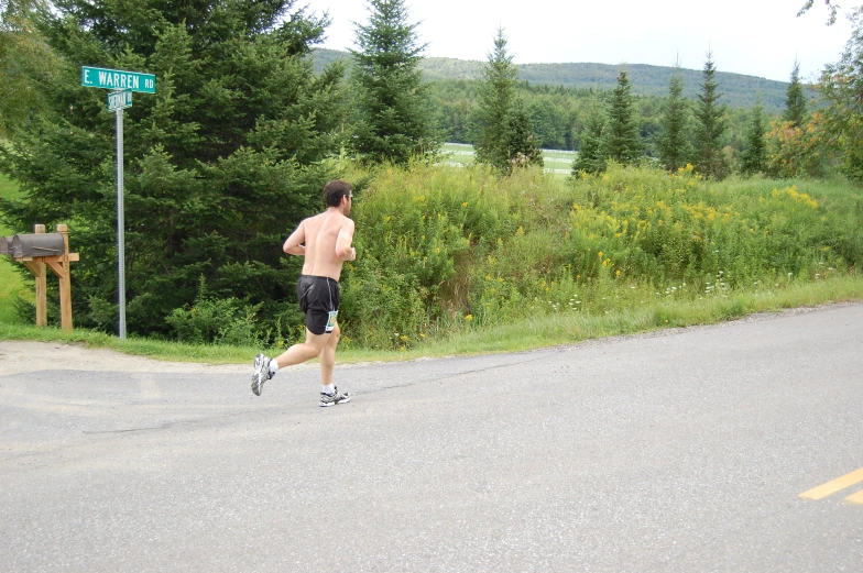 a man jogging in the middle of the road