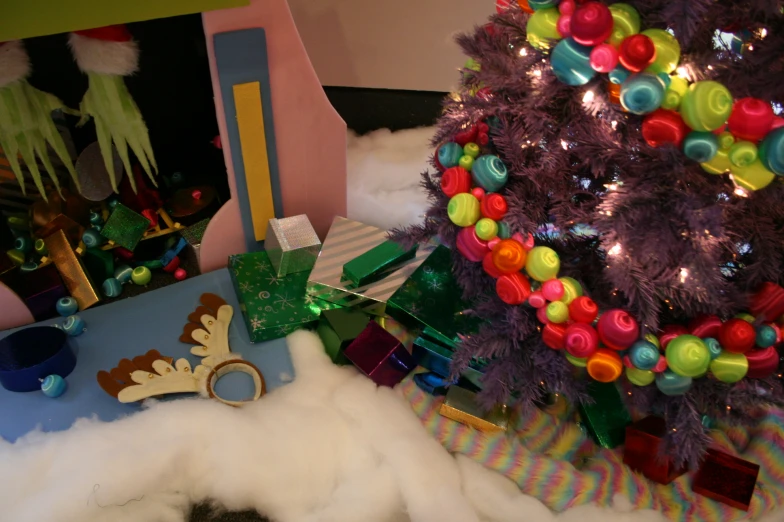 a snow machine sitting under a christmas tree