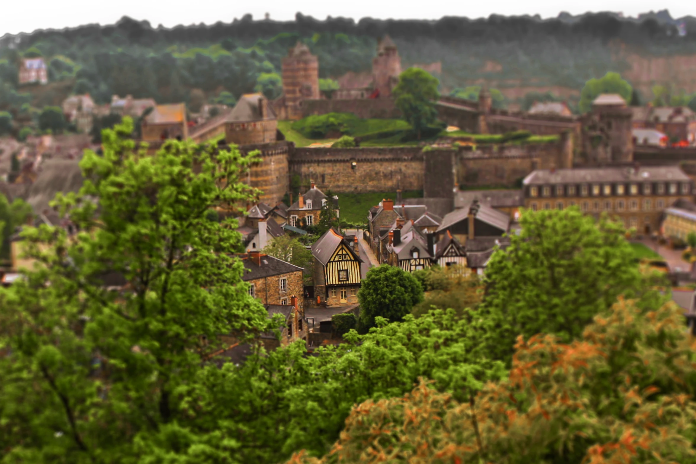 a view over a city with green trees