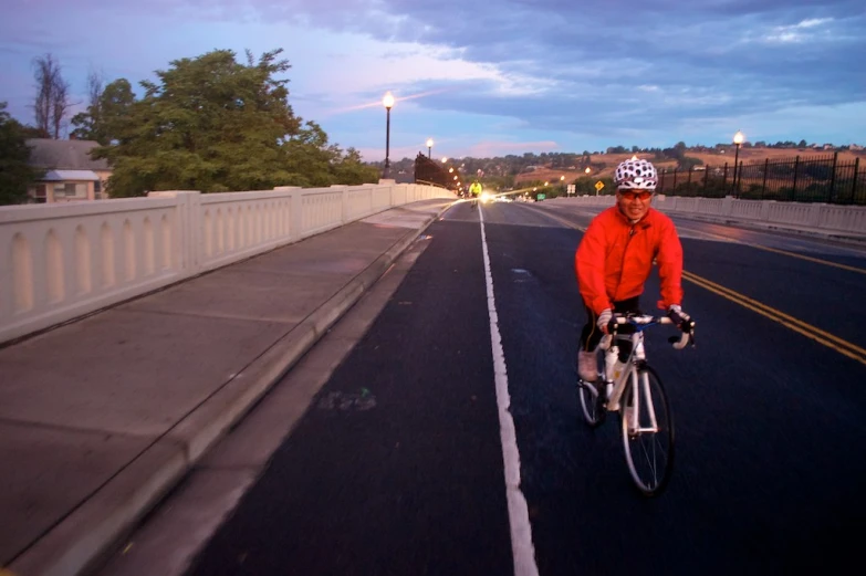 a person riding a bike on a bridge