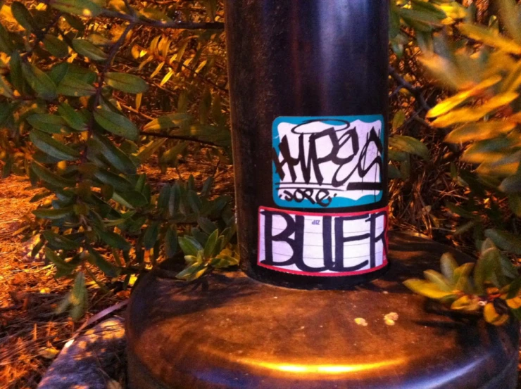 an old fashioned metal pole with graffiti on it