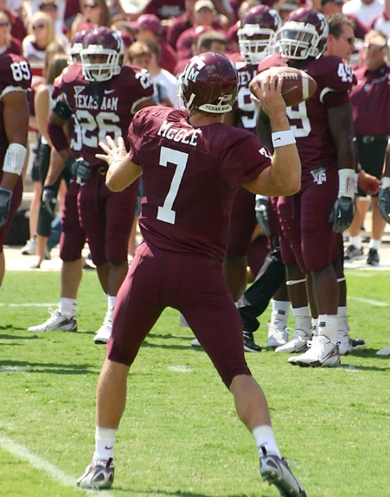 a team of male football players playing on a field