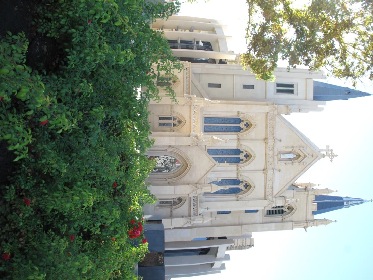 an old church with several steeples and roses below it