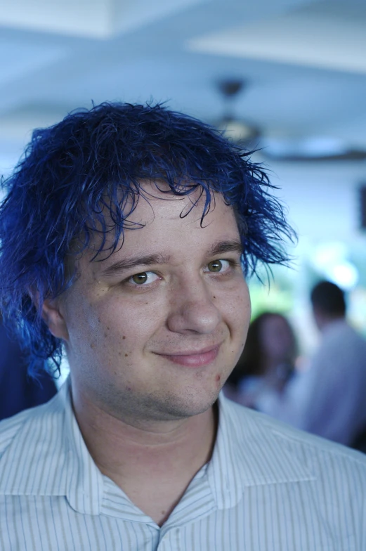 a man with a weird purple hairs has blue dyed hair