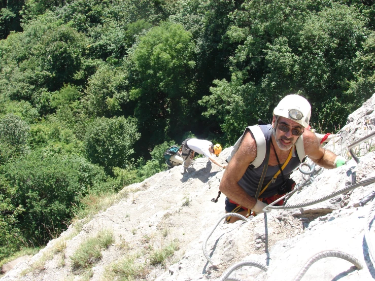 a man climbing up some rocks on a mountain