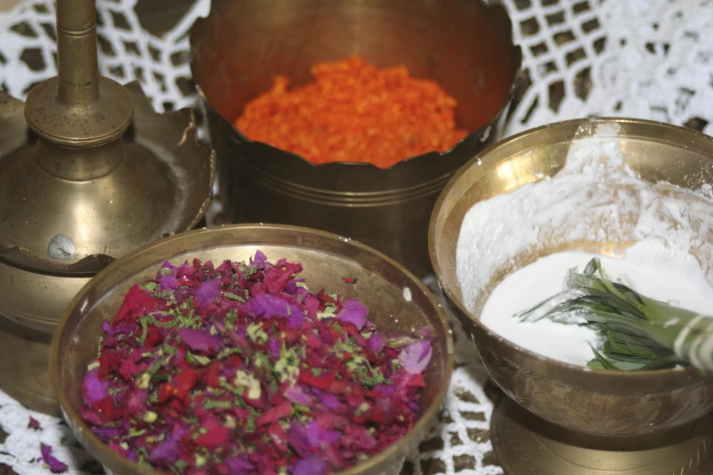 different colored flower petals in a bowl and a tea tray