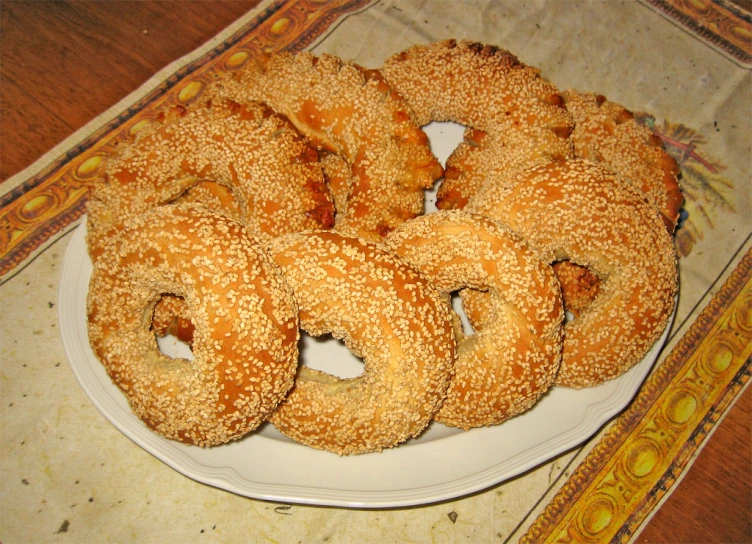 large fried doughnuts on a plate with a towel