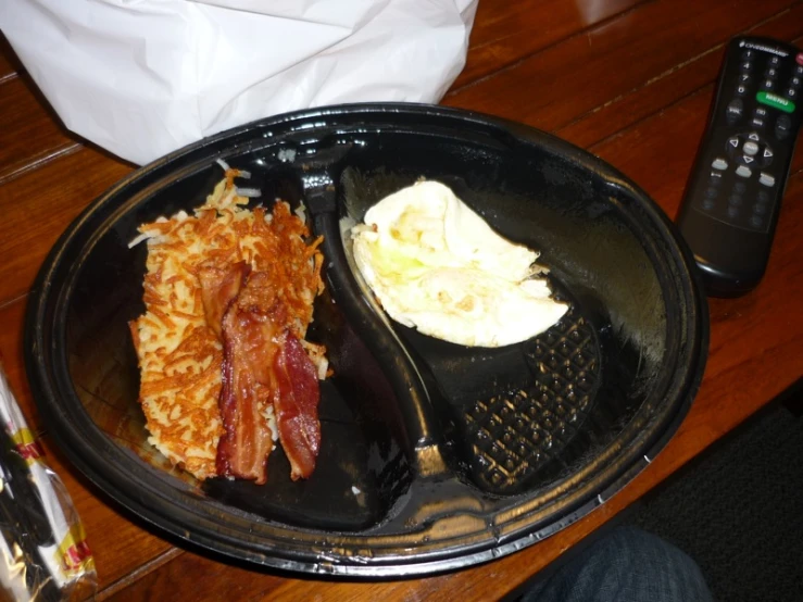 there is an individual breakfast that includes bacon and eggs