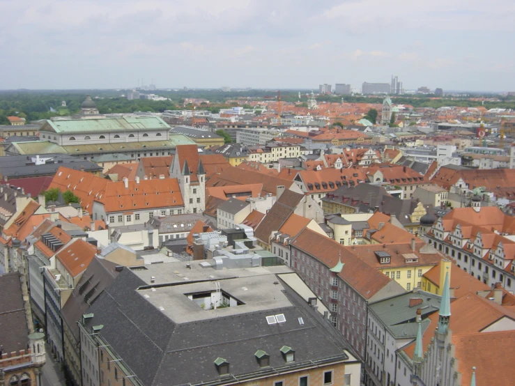 a large city with many roofs and trees