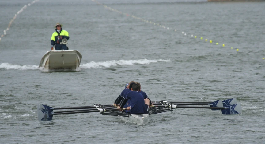 two men are in their boats racing across water