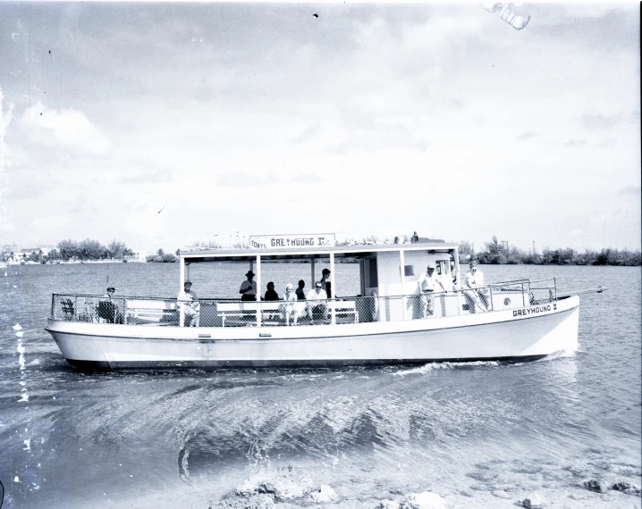 a boat with people and other boats in the water