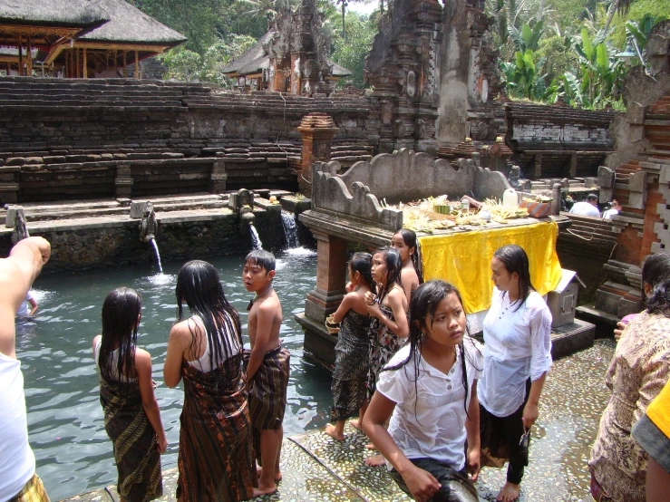 several women standing near the water by an entrance