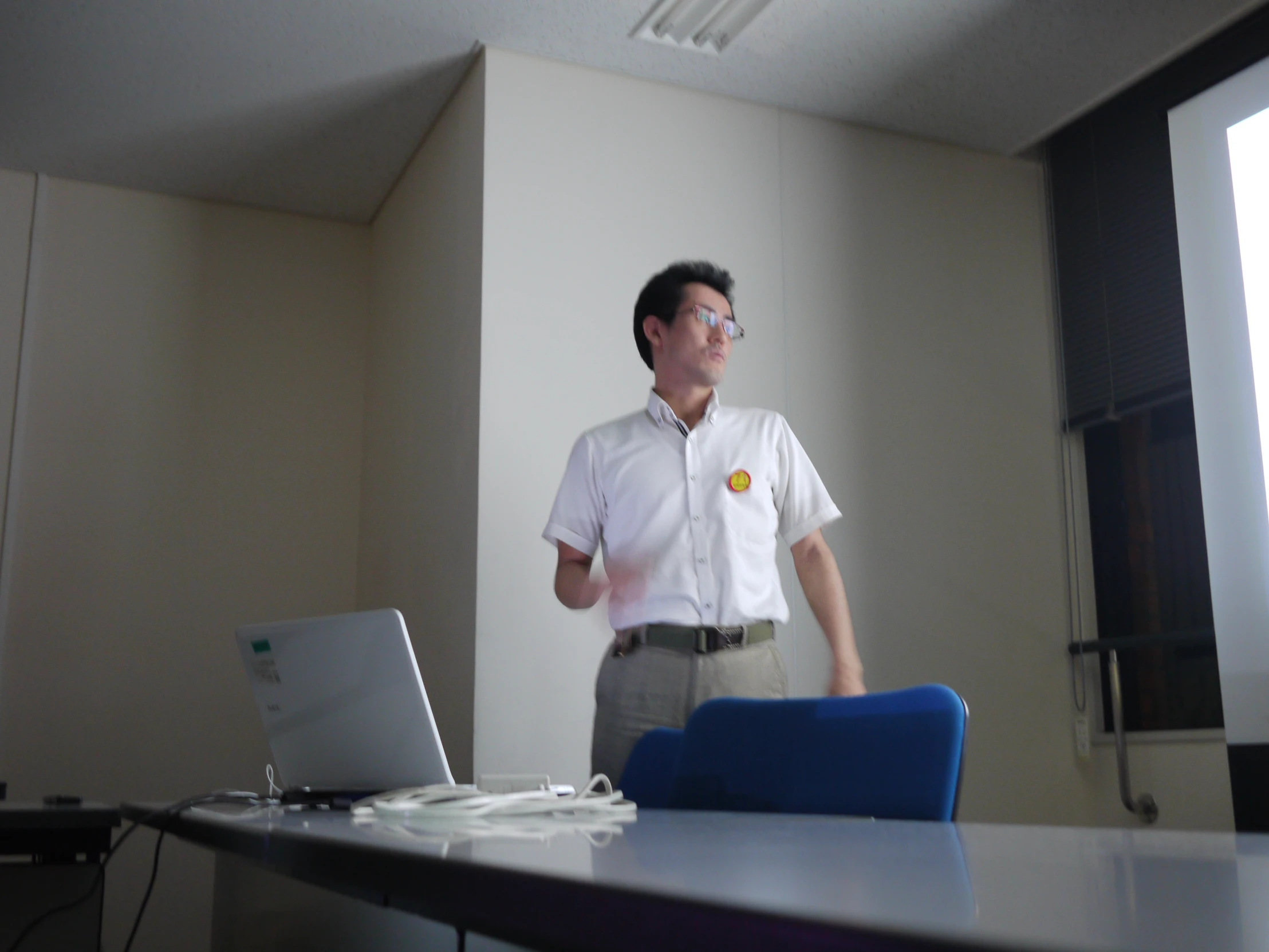 a man standing in front of a laptop computer