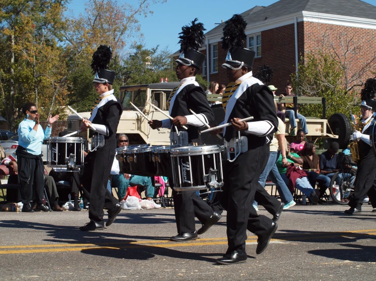 there are many men dressed in black outfits marching