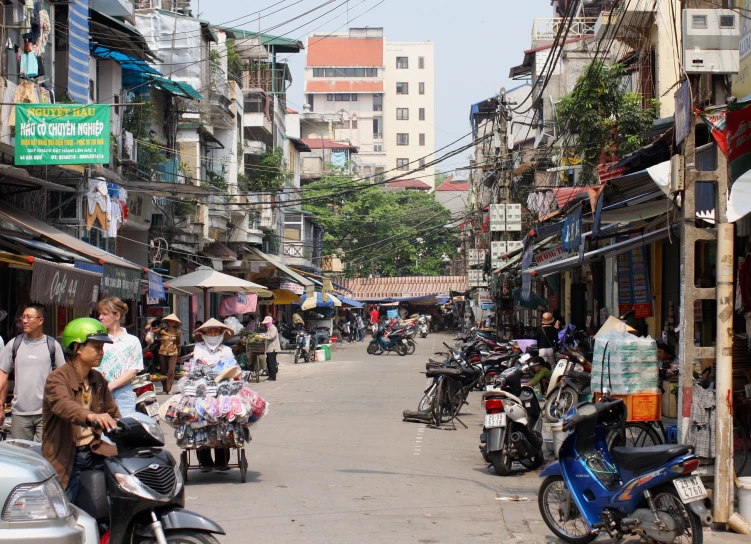 many people in the distance are on motor scooters