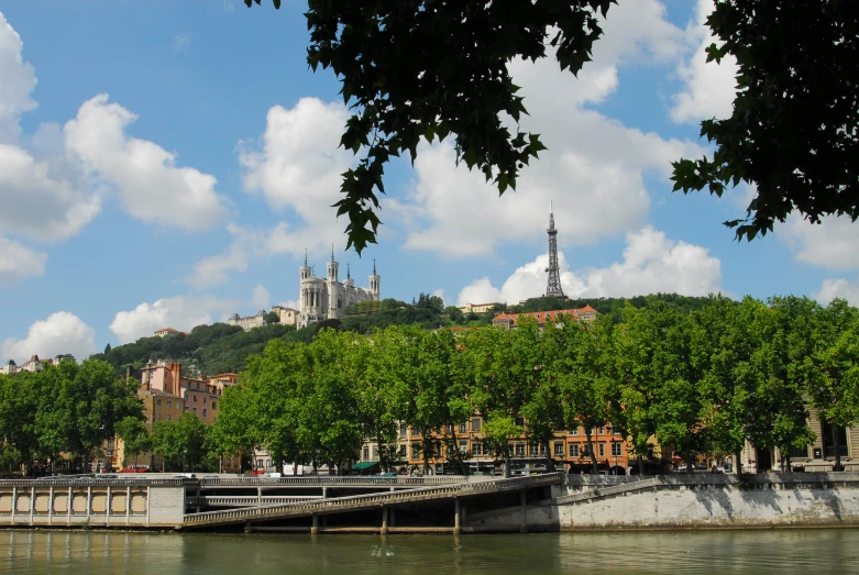 a city sitting on a hill overlooking a river