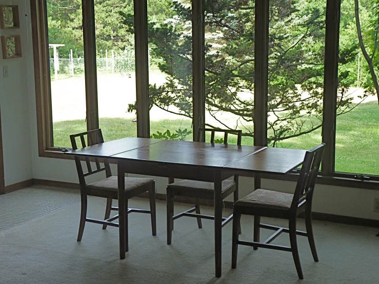 this is a po of a table and chair in front of a window