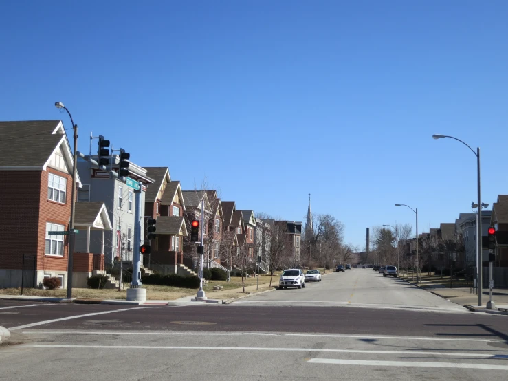 a street with rows of houses lined with small trees