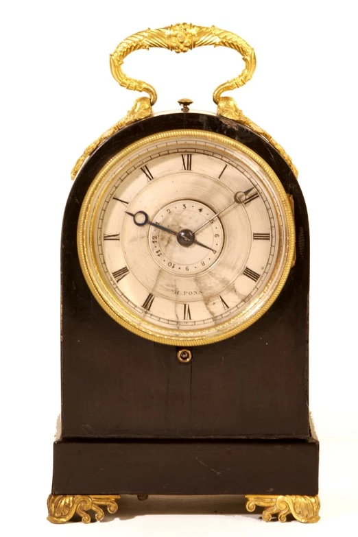 an antique clock that is on display on a stand