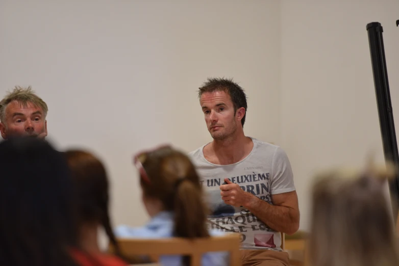 a man standing at the front of a room