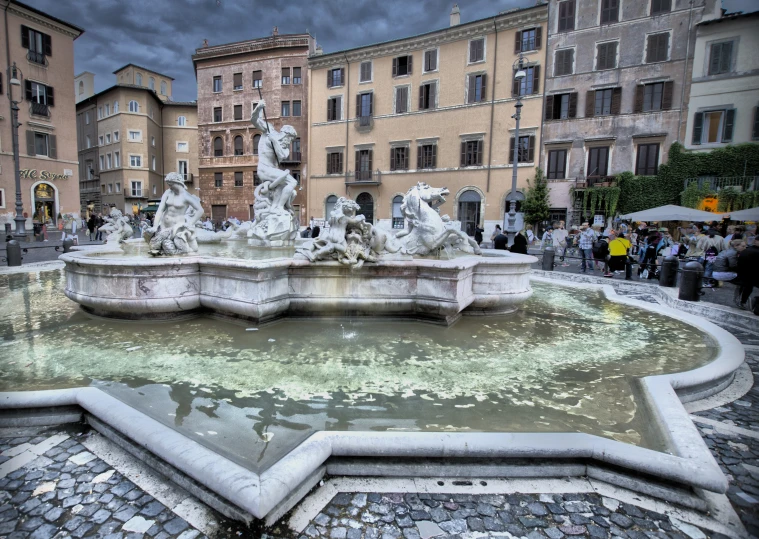 the stone fountain has a water fall on it