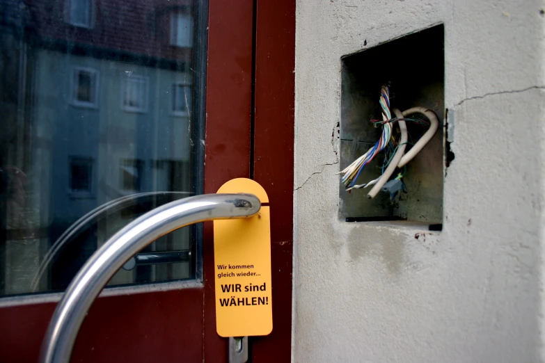 electrical wiring in a box attached to the front door of a house