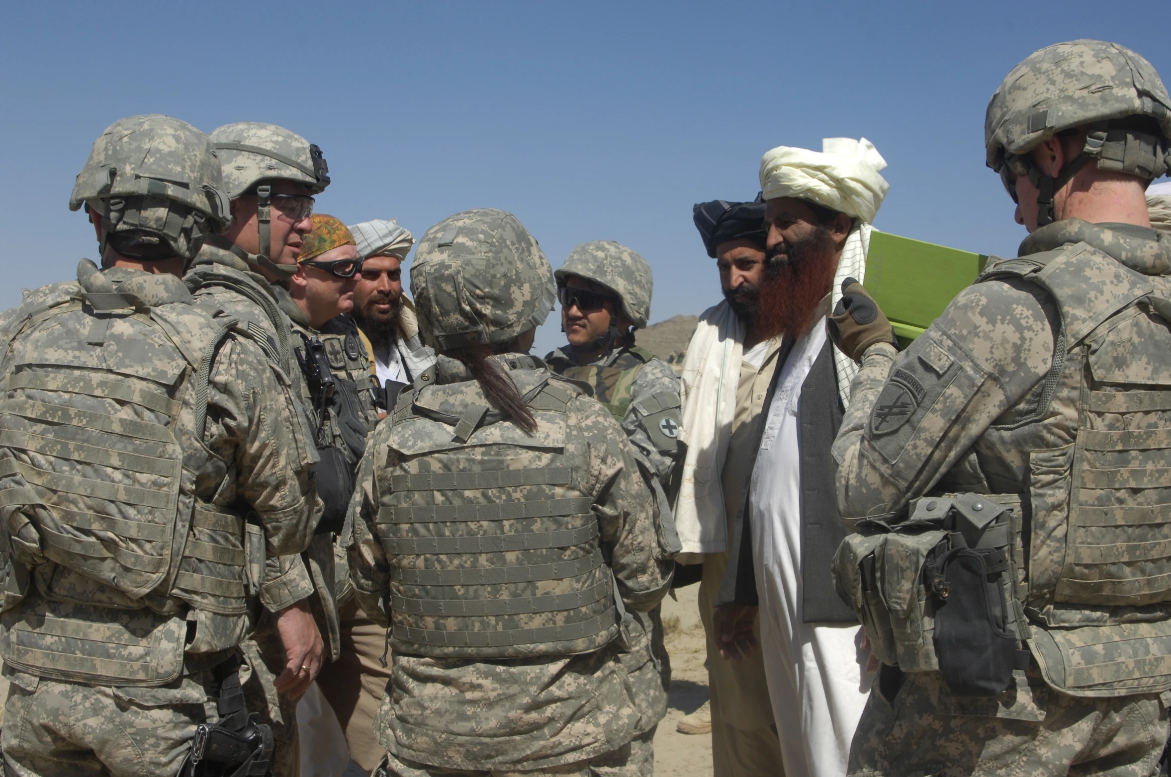 a group of soldiers gather together talking