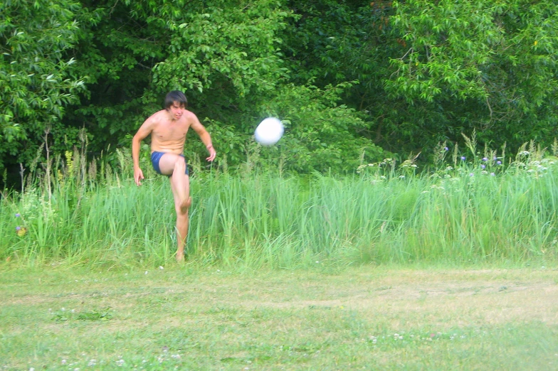 a man throwing a frisbee over a field