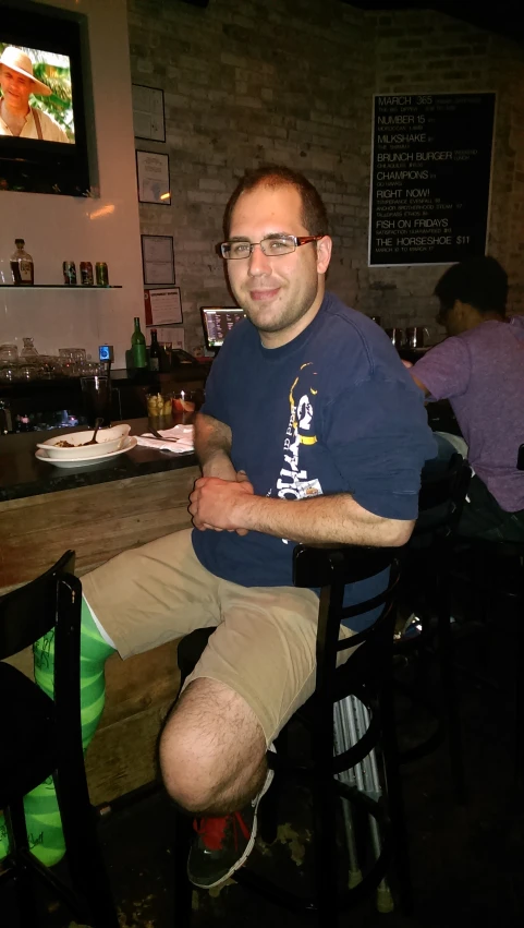 a man sitting in a chair at a bar