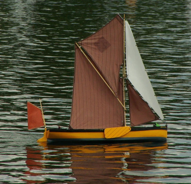 this is an image of a little sailboat on water