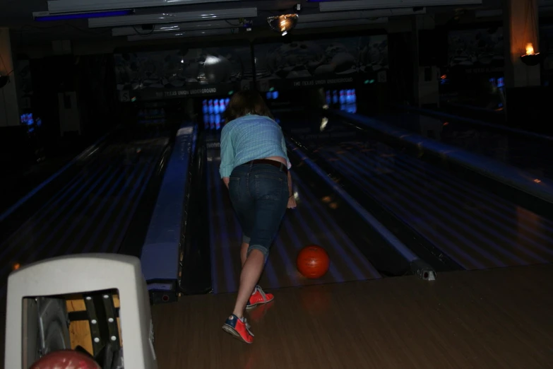 a person that is standing up with bowling balls