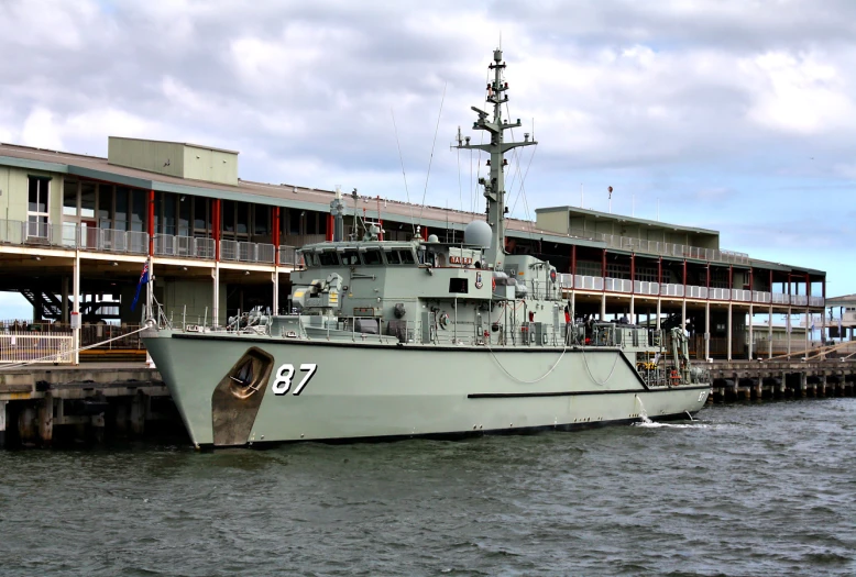 large gray ship docked in the middle of the water