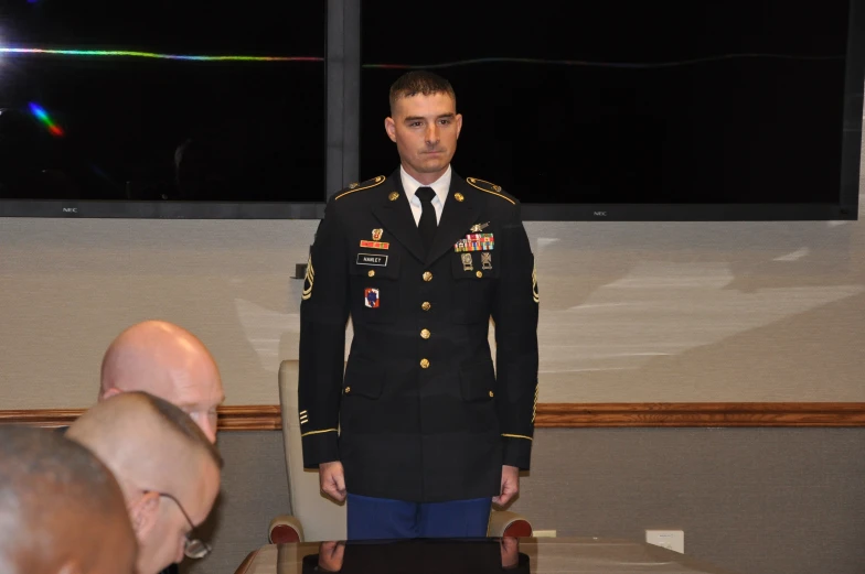 a military man in uniform talking to someone