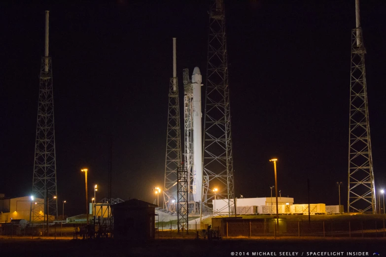 a space rocket sitting on top of a black field