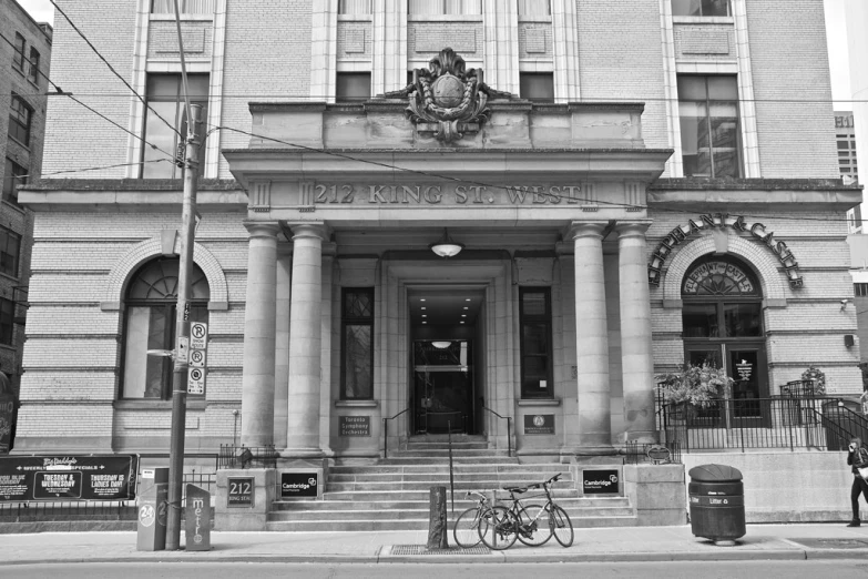 an old building with some bicycle and bicycle rack next to it