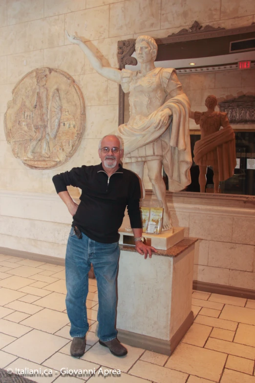 a man standing next to a white statue in front of a clock