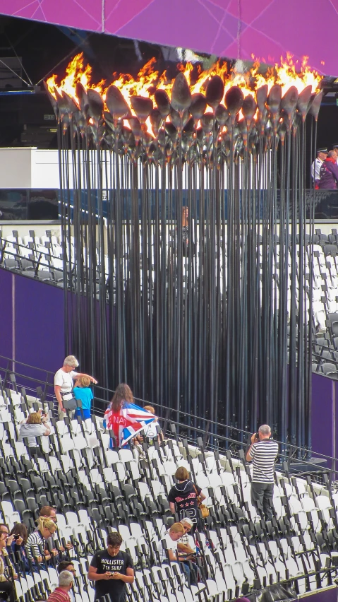 the flames of the olympic rings over the fans