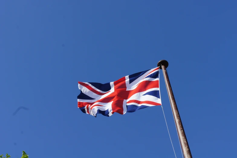 a british flag is being waved in the wind