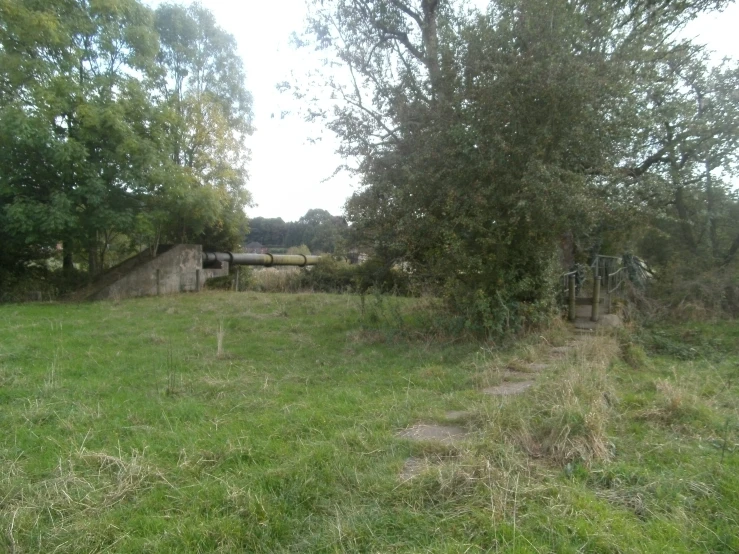 an old building and a gate are in the middle of the field