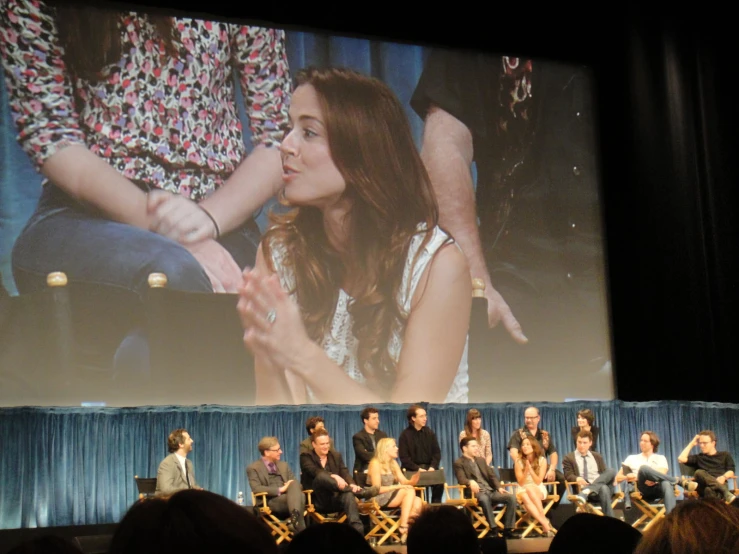 people sitting on a stage during a conversation