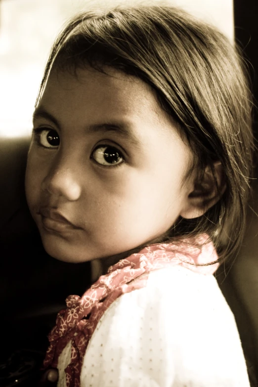 a little girl that has a scarf around her neck