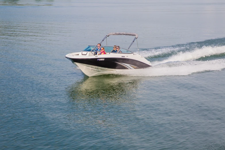 a black and white motor boat driving through the water