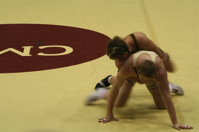 two wrestlers crouch together before wrestling