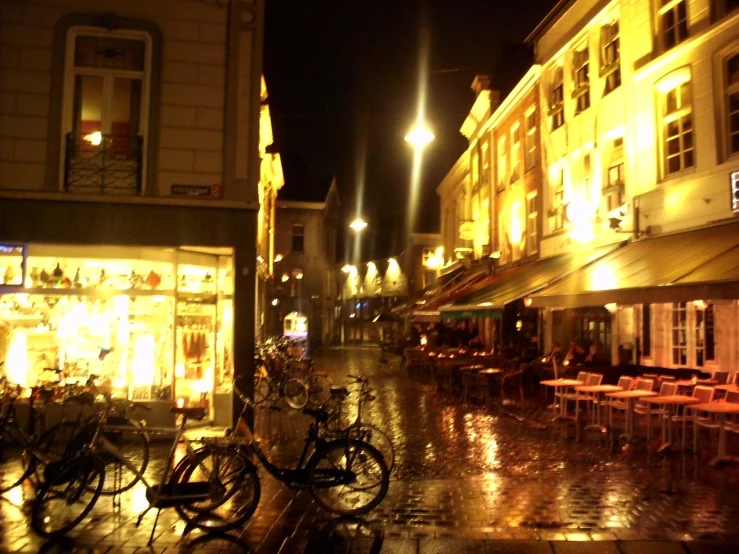 bicycles are parked on a city street at night