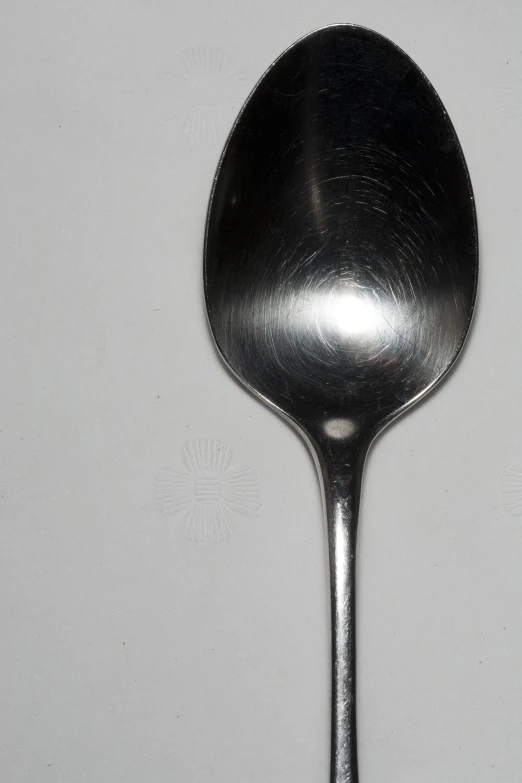 a metal spoon with one side missing is seen