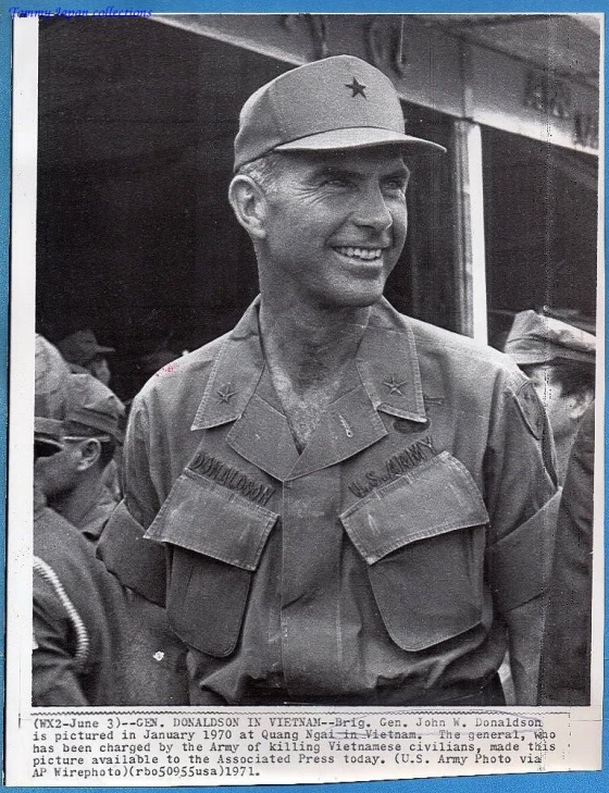 a man wearing a uniform smiles for a picture