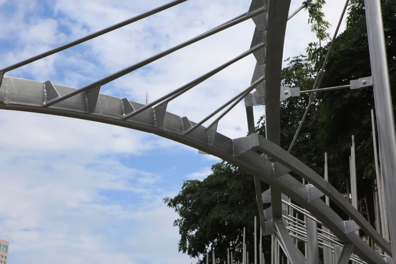 a white metal bridge that has multiple wires and poles
