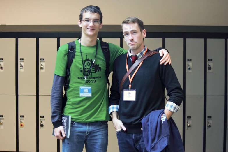 a couple of men that are standing in front of lockers